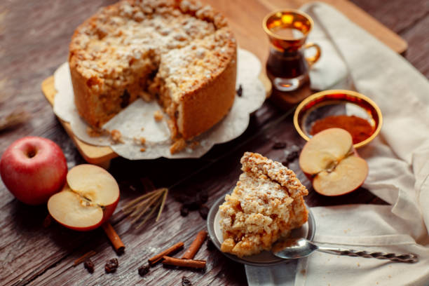 istock Homemade delicious apple pie with different ingredients on rustic background. Classic autumn Thanksgiving dessert - organic apple pie. 1249232072