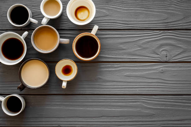 istock Many cups of coffee on wooden table top-down copy space 1249232153