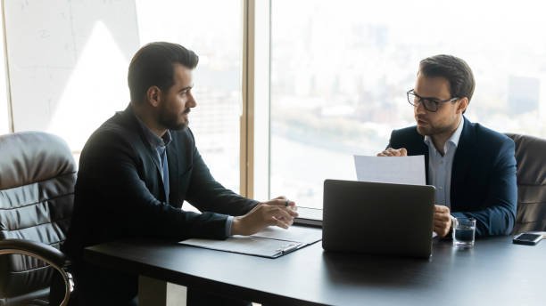 istock Business partners discussing contract conditions, sitting at table in office 1249232513