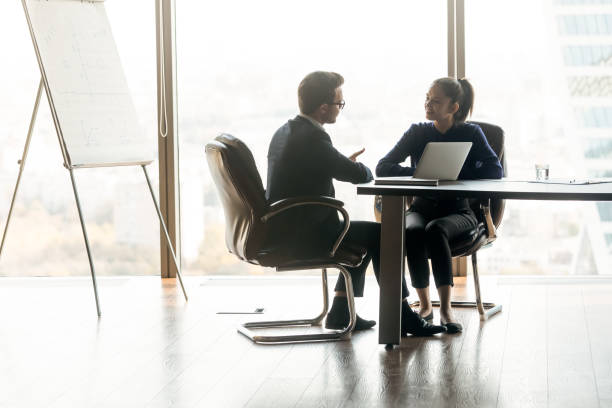 istock Two business partners discussing project strategy in modern office 1249232525