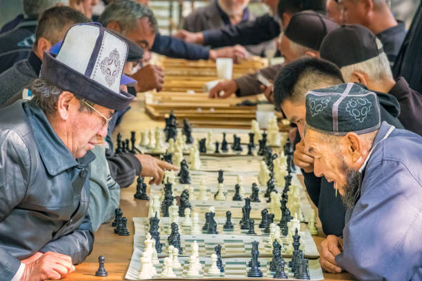 Men play chess and games outdoors in Osh Kyrgyzstan