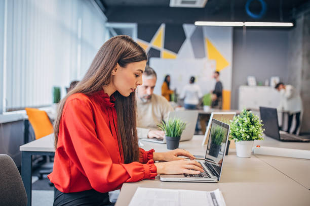 istock Beautiful woman working in big modern office 1249236508