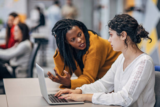 istock Beautful women working on laptop in big modern office 1249236586