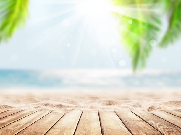 Wooden table top on blue sea and white sand beach background.