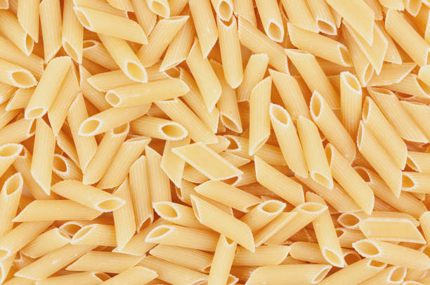 istock Scattered lot of raw pasta. Background or texture 1249238504