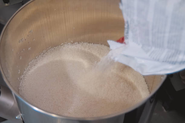istock Pouring polymer granules into steel tank. Making explosives. 1249240260