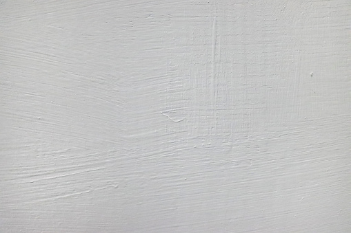 Wall background painted with a white paint brush.