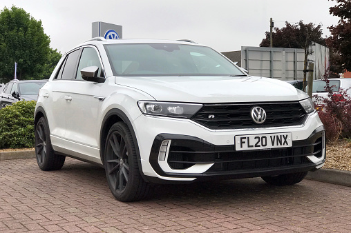 Burton upon Trent, Staffordshire - 12 June 2020: A white Volkswagen T-Roc R performance SUV parked outside VW dealership. The T-Roc R has a 2.0 litre 300PS engine that can accelerate from 0 to 62 mph in 4.9 seconds.