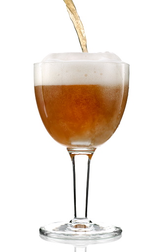 beer being poured into specific glass on white background