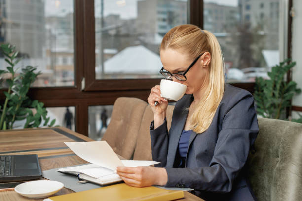 istock Business woman drinking coffee in office 1249247749