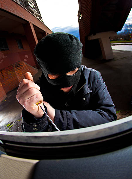 istock thief in a mask hijacks the car 124924811