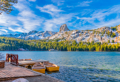 Boats sit at dock at Lake George under the watchful eye of the Crystal Crag peak.  This peak is in Mammoth Lakes in Central California, in Sierra Nevada Mountains,
