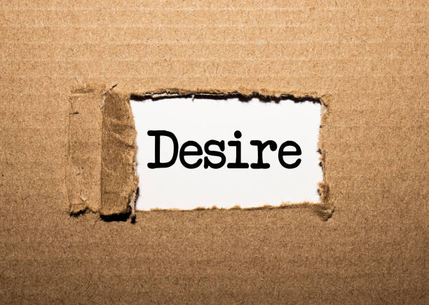 istock The text DESIRE. behind torn brown paper 1249250808