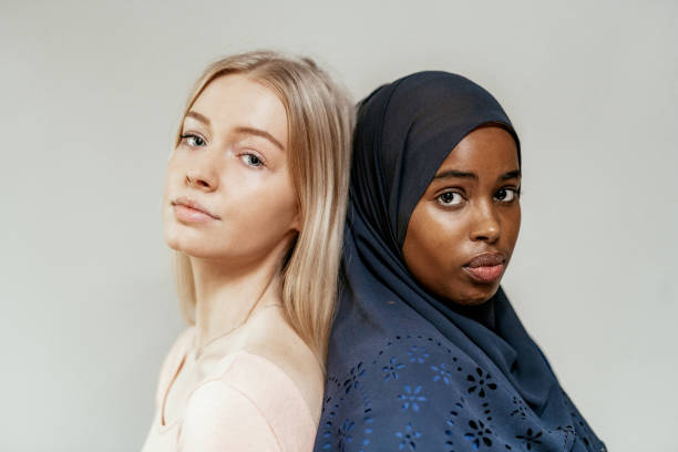 Close up of blue eyes and blonde hair Nordic woman and Middle Eastern woman with hijab Generation Z and Millennials lifestyles in Nordic countries skin tones stock pictures, royalty-free photos & images