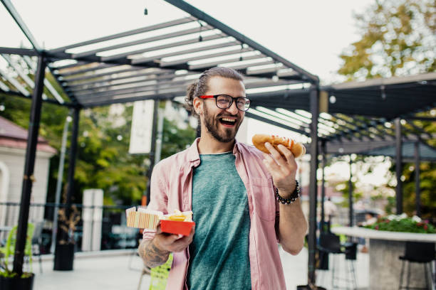 istock Young man eating fast food 1249251854