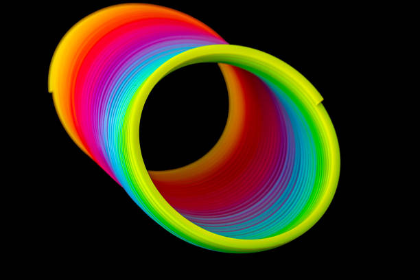 istock Colorful slinky isolated on black background 1249253129