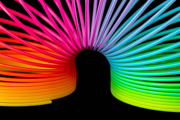 istock Colorful slinky isolated on black background 1249253139