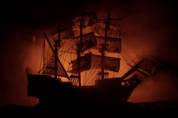 istock Black silhouette of the pirate ship in night 1249256143