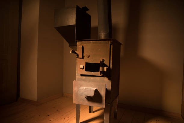 Image with fire flames inside a white wood burning stove and a black kettle