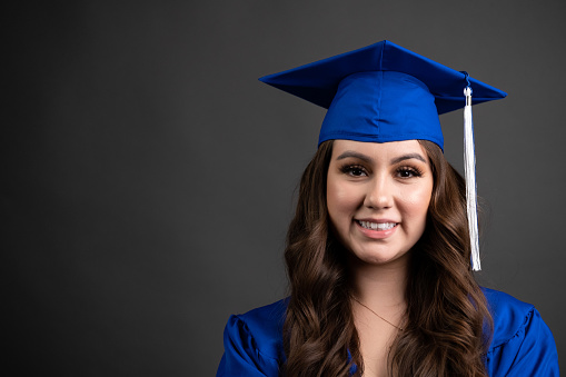 Smiling young hispanic woman celebrating her graduation