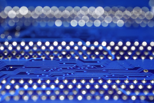 Blue printed circuit board texture with selective focus and blurred background and foreground