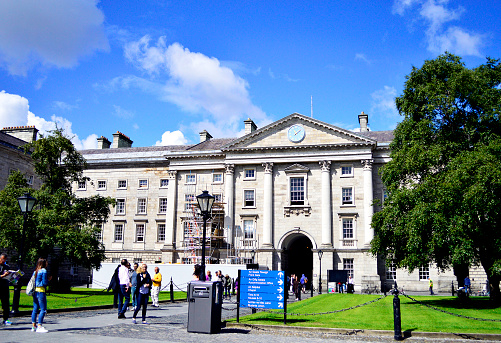 Dublin, Ireland, July 2016. People walking in front of the main entrance of Trinity College Dublin in a sunny day, Ireland.