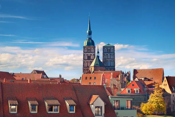 Orange tiled roofs of Stralsund. Skyline with towers of medieval parish Church of St. Nicholas, Stralsund, Germany