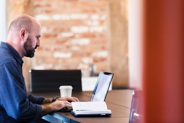 istock Confident businessman uses laptop 1249259971