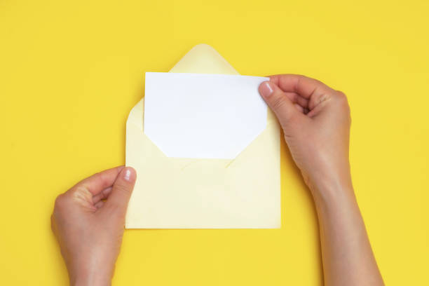istock Woman hands holding an open envelope with blank white card 1249259977