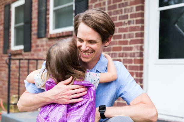 istock Father smiles as daughter hugs him before getting on bus 1249260076