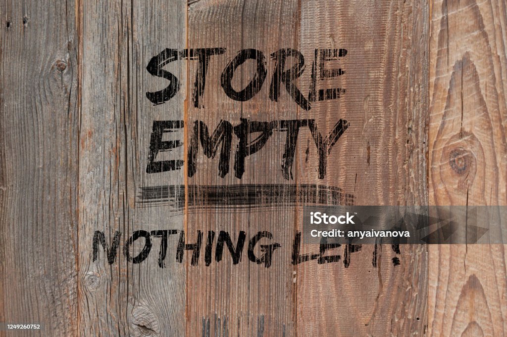 Text "Store empty nothing left" painted black on wooden boards. Boutique shops and stores boarded up. Concept background with text. Protests, riots and looting in New York City. Text "Store empty nothing left" painted black on boarded storefront. Boutique shops and stores boarded up against violence. Aftermath concept with text. Protests, riots and looting in New York City. 2020 Stock Photo