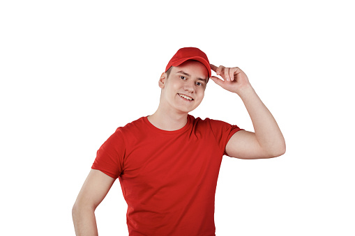 Young handsome confident guy from delivery service, white background. The guy in the red uniform.