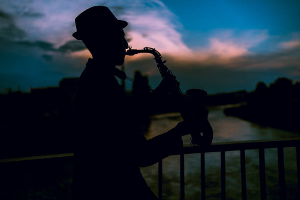 istock Sax man silhouette at sunset 1249260910