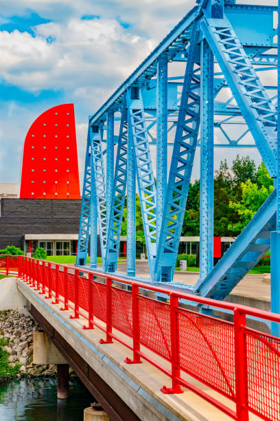 A woman walks with a baby stroller across the Walnut Street Bridge, built in 1890, in Chattanooga, TN. (June 2019)