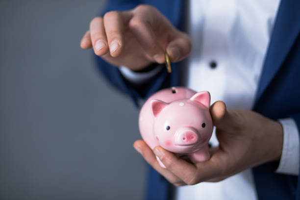 istock hand coin with piggy bank 1249261006