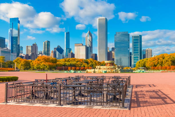 Grant Park in autumn with the Chicago skyline, Ill Tables and chairs in the Grant Park bricked area sit in front of fall colored trees and an  extensive panorama of the skyline of Chicago. 3610 stock pictures, royalty-free photos & images