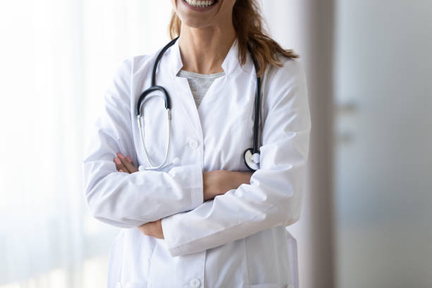 istock Cropped smiling female doctor in white uniform with stethoscope 1249263069