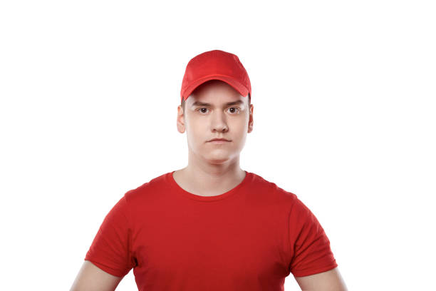 istock A young guy in a red cap, a white background. Delivery service. 1249263316
