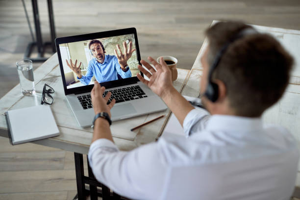 istock Two business colleagues discussing while having online meeting over a computer. 1249265248