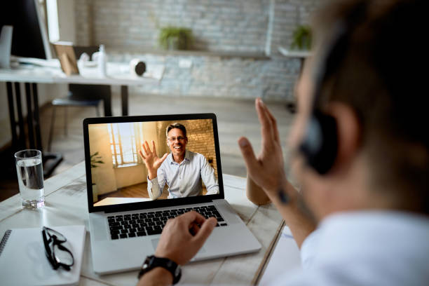 istock Happy business colleagues greeting while having online meeting. 1249265261