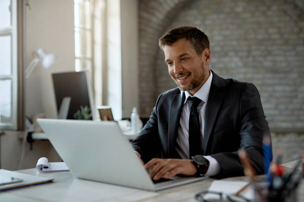 istock Happy male entrepreneur working on a computer in the office. 1249266187