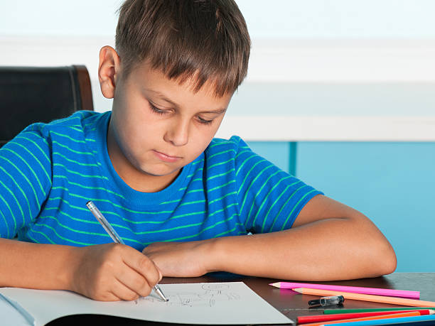 istock Drawing boy at the desk 124926717
