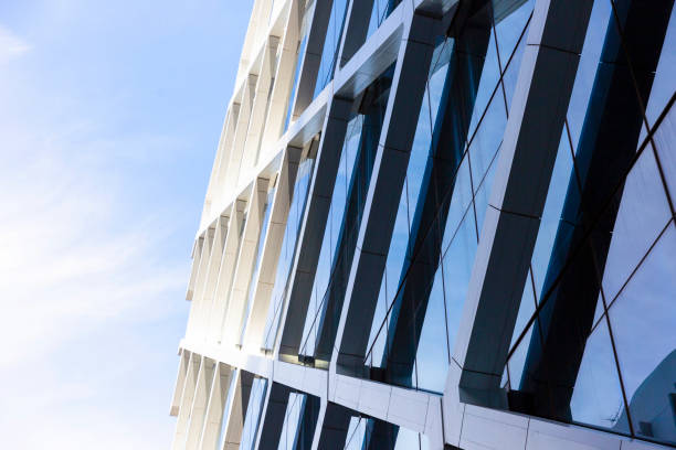 Low angle view of modern office building, skyscrapers, sky background with copy space