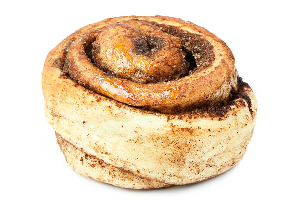 close-up of an unfrosted sweet bun with cinnamon on white - kanelbulle bildbanksfoton och bilder