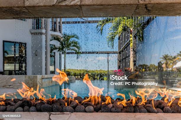 Unique Firepit Poolside With Waterfall Stock Photo - Download Image Now - Fire Pit, Swimming Pool, Yard - Grounds