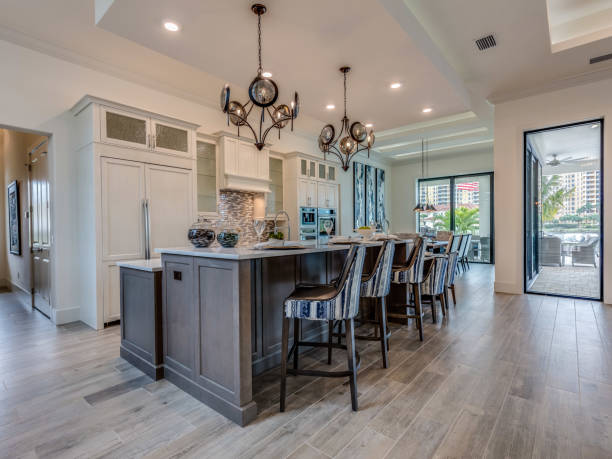 View of kitchen with island and white panel refrigerator Beautiful contrast of brown and white kitchen florida real estate house home interior stock pictures, royalty-free photos & images