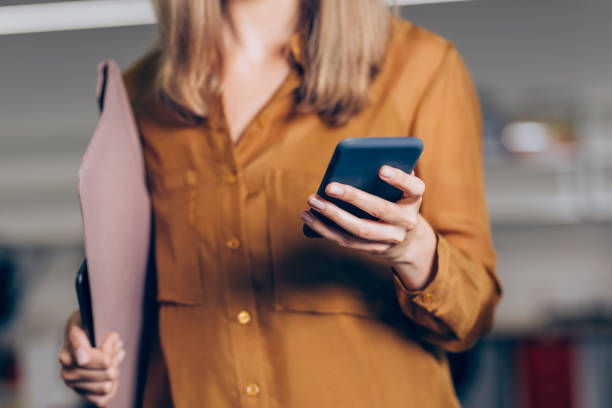 istock Hands of an Anonymous Businesswoman Using her Smartphone at Work 1249281450