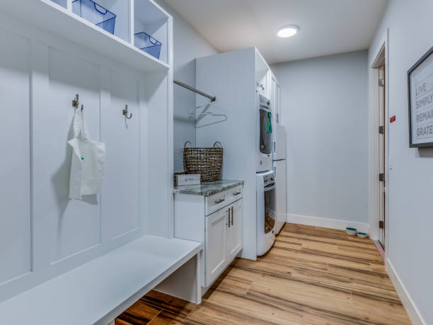 Exceptional space design combining laundry room and mud room Stackable washer and dryer conveniently located next to mud bench, coat hooks and cubbyholes stackable stock pictures, royalty-free photos & images