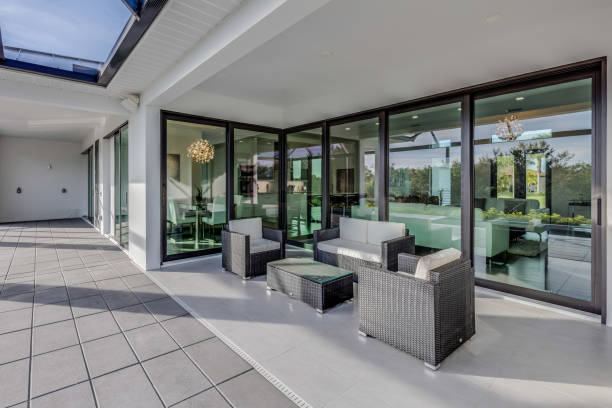 istock Covered patio with glass wall opening to the inside 1249282991