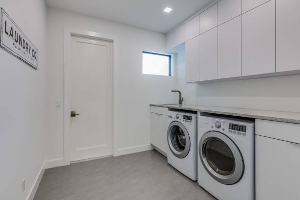 istock White laundry room with brand new washing machine and dryer 1249283017